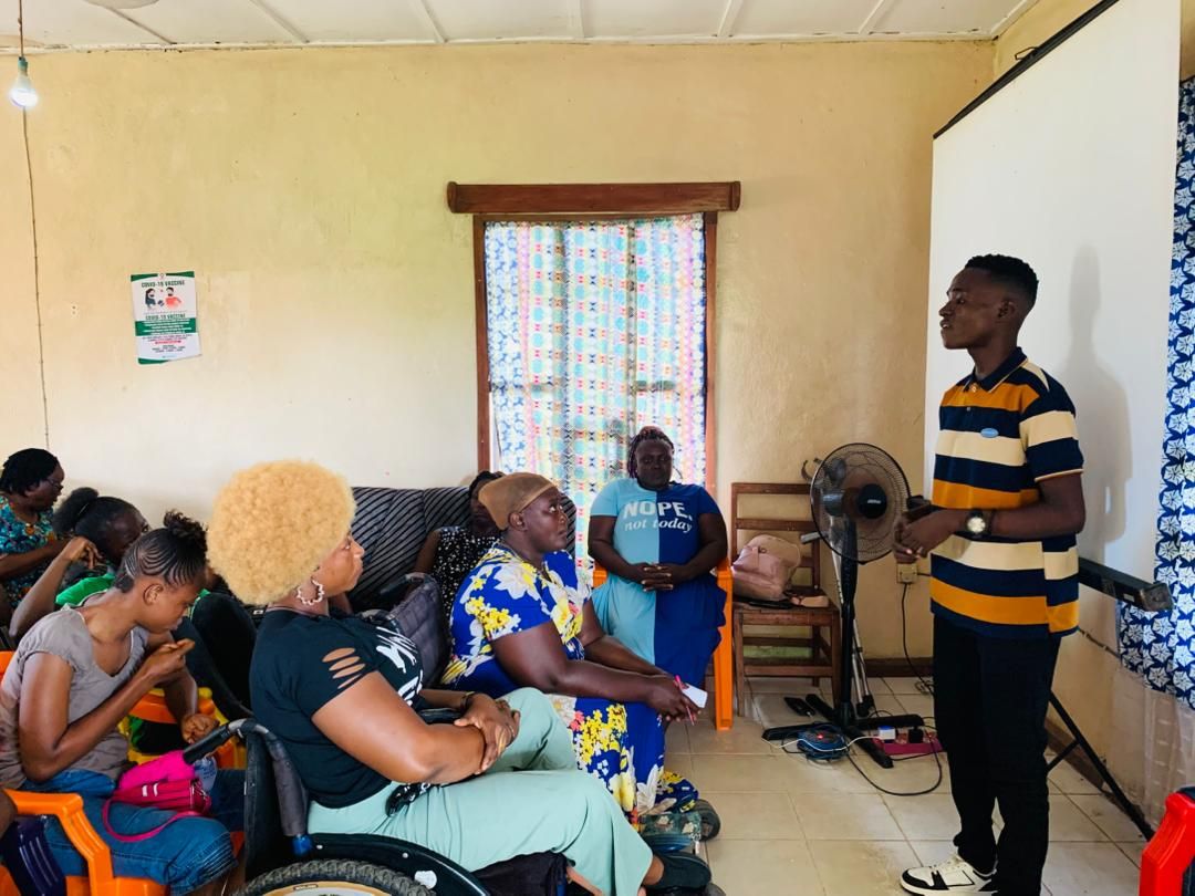 Participants seated and engaged listening to a facilitator during the gender law empowerment session in Grafton